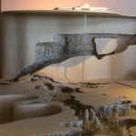 This shows the natural entrance on the back wall. The tube represents the elevator going up to the visitor center, and the foreground shows the Big Room of the cave.