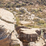 During Summer Solstice the rising sun shines through the crack in the rock and hit the spiral on the darker rock below.