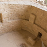 These underground rooms were used as ceremonial and craft rooms. A fire was built in the center and fresh air came in through the chimney to the right. A two foot thick roof would rest on the pillars on the sides.